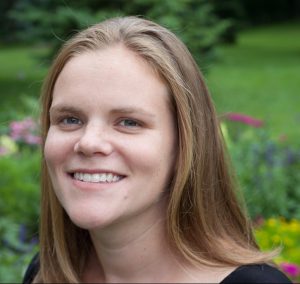 Dr. Brooke Richardson, posing outside near a garden. She has blonde shoulder-length hair