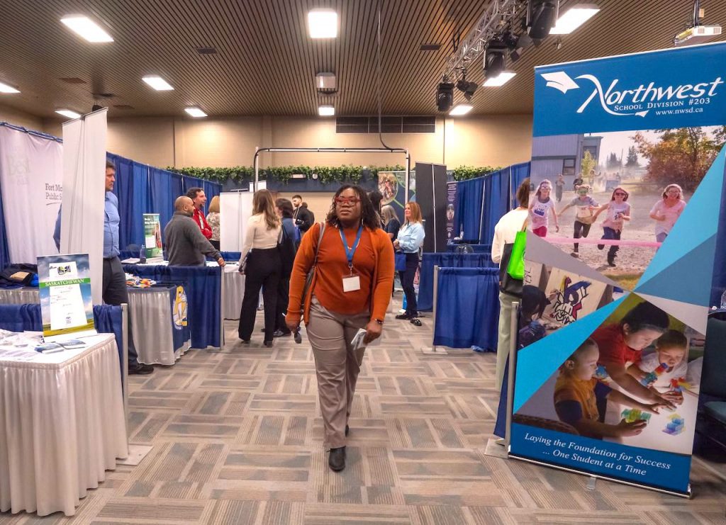 A B.Ed. students walks between booths at the B.Ed. Job Fair