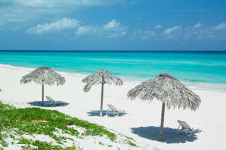 A picture of a white, sandy beach and the ocean.