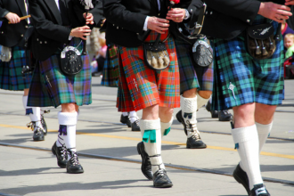 A picture of bagpipers in kilts