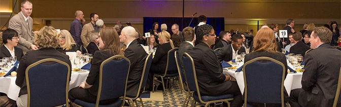Business and Tourism students and attendees sitting at tables during a conference