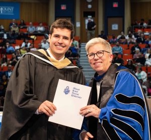 MSVU business administration degree student on stage with president at the May 2026 graduation ceremony. Both look very happy.