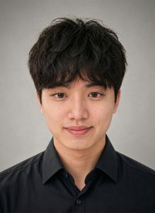 Headshot of Jiahao Wang 2026 Pacrim scholarship winner in the Tourism and Hospitality Management program at MSVU. Jiahao is an Asian man with dark hair, a black shirt and is standing in front if a grey background. And he is smiling. 