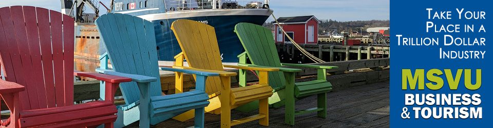 This is a photo of four Adirondack chairs, a red one, blue one, yellow one, and a green one on a wharf in front of a ship tied up beside a red shack, with multiple wharfs to the right. To the right with a dark blue background are the words in white, take your place in a trillion-dollar industry and under that the MSVU business and tourism logo.