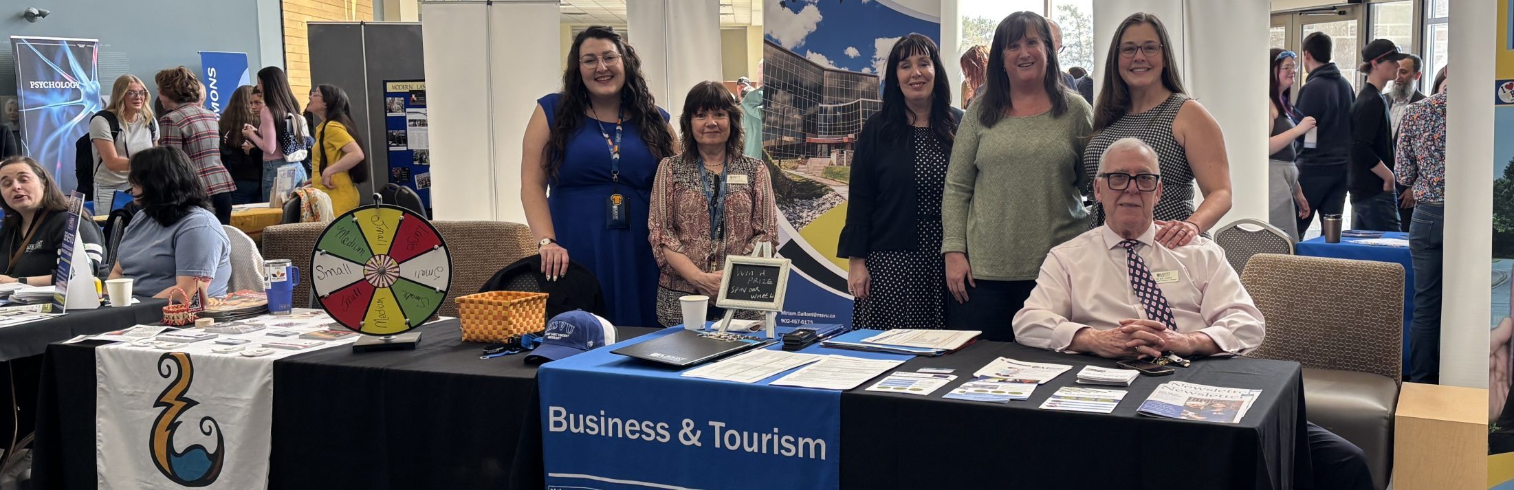 Business and Tourism instructors and staff giving information at a open campus day event May 2026