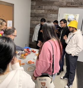 Sustainable business tour students lined up testing apples at Scotia Gold - fall 2023.