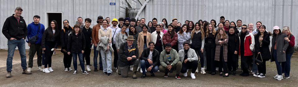 Students from the fall 2023 sustainable business tour standing in a line outside of Melvin Farms at the end of their day.