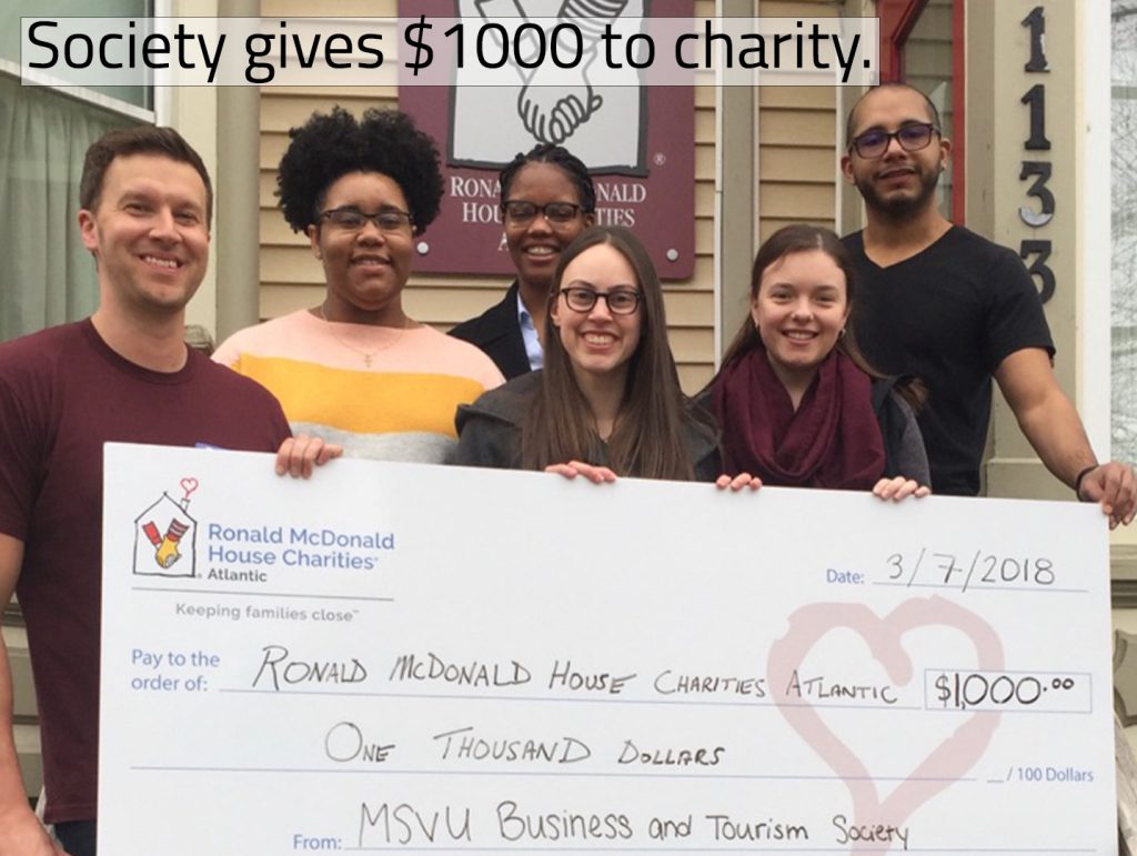 Business and Tourism society holding huge cheque outside of Ronald McDonald House containing a donation of $1000 in 2018.