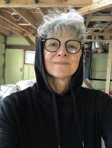 Brenda Hattie, professor in Women's Studies at MSVU, wearing a black hoddie with glasses.