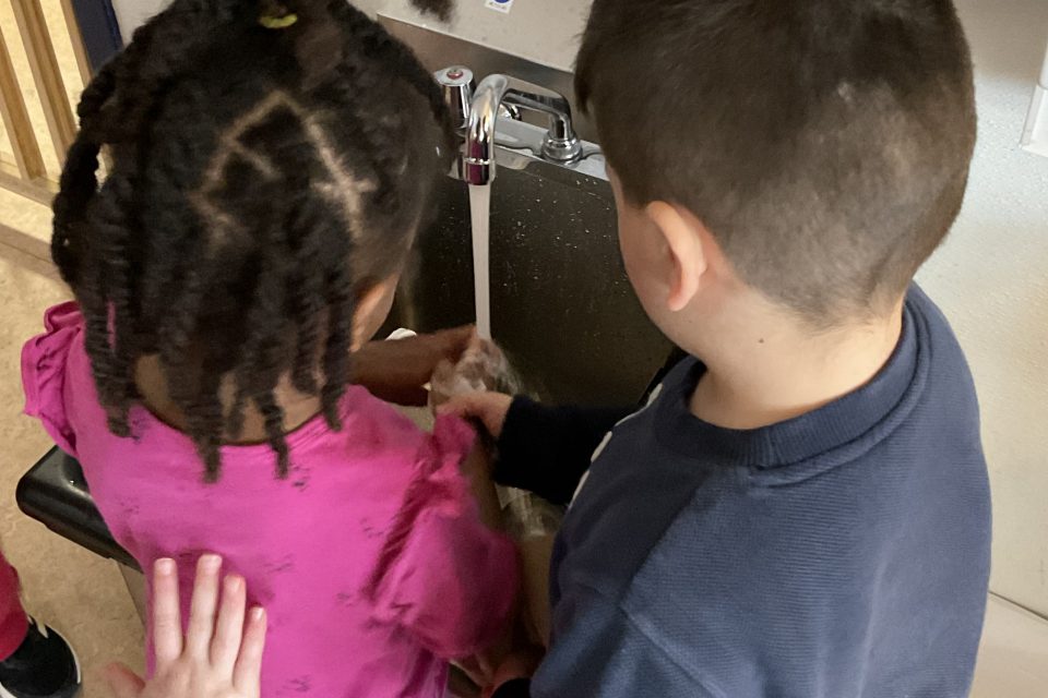 Two children washing their hands at the Child Study Centre