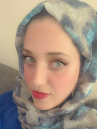 Asmaa wearing a blue and grey hijab with a blue shirt