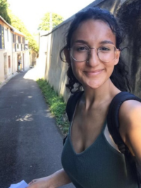 Mount Mentor Lily wearing glasses and a backpack in a tourist shot.