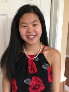 Emily - a Chinese-Canadian woman wearing a floral print dress 