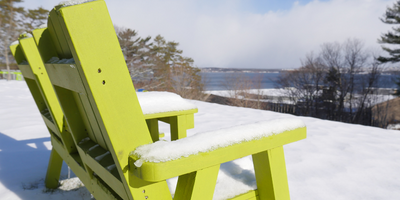 Green bench outside Evaristus covered in snow.