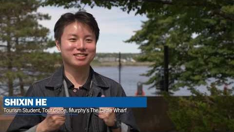 Tourism and Hospitality Management student Shixin He on the Mount grounds by the water talking about the tourism program