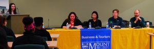 People sitting at table. Tourism and Hospitality Management Career Week panelists. 