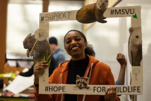 Mount Business and Tourism student holding their SE4D project for hope for wildlife 2020. 