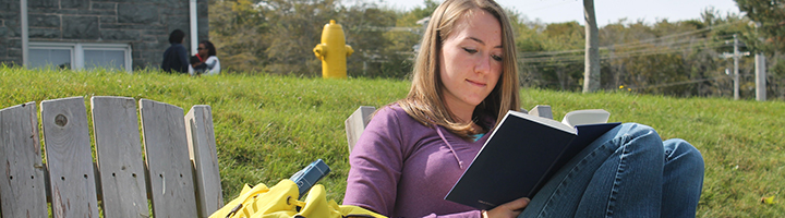 720x200 Student Studying in Front of Evaristus