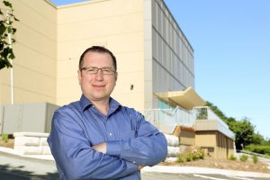 Dr. Luhovyy standing in front of research building