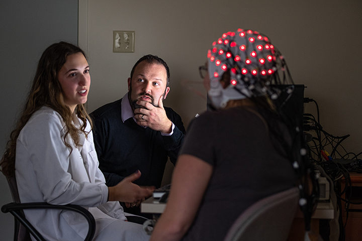 Derek Fisher with Tara Perrot and participant in EEG lab