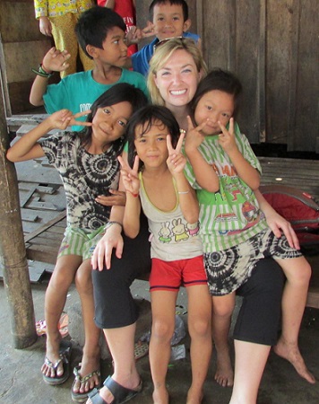 Kyly with children in Cambodia