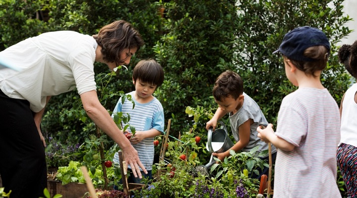 Teacher and kids in a garden