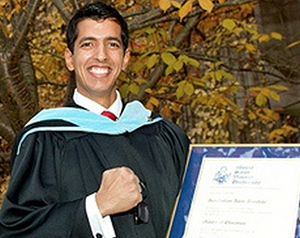 Graduate Student holding their degree outside of Seton Academic Centre