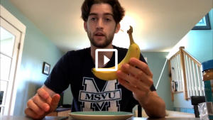 man holding a banana preparing a snack