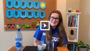 Women prepping a science experiment with two glasses of liquid sitting on a table