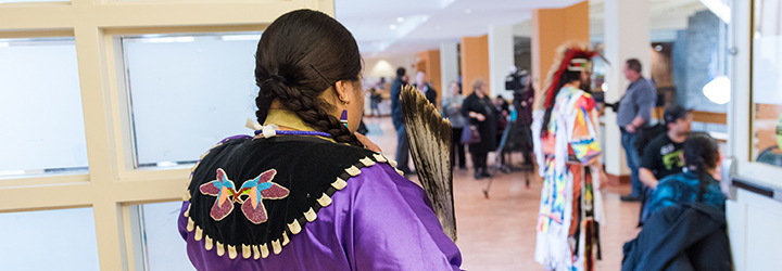 A Women looking over the Mid-Winter Feast event at Mount Saint Vincent University