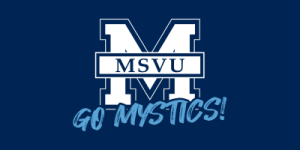 The image shows a large white letter 'M' with a blue outline on a dark blue background. Inside the 'M,' there is a white rectangular box with the text 'MSVU' in blue capital letters. Below the 'M,' the phrase 'GO MYSTICS!' is written in light blue, stylized script font.