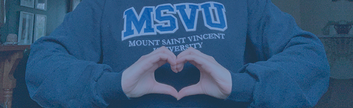 A MSVU hoodie with the hand making the shape of a heart