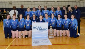 MSVU women's volleyball team with ACAA banner