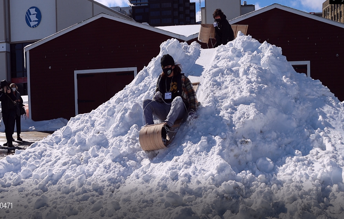 Youth from Sipekne’katik First Nation sledding with their newly built toboggans on the Halifax waterfront