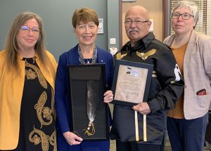 Dr. Ramona Lumpkin holding Eagle Feather, surrounded by three members of the L’nu Advisory Circle at MSVU.