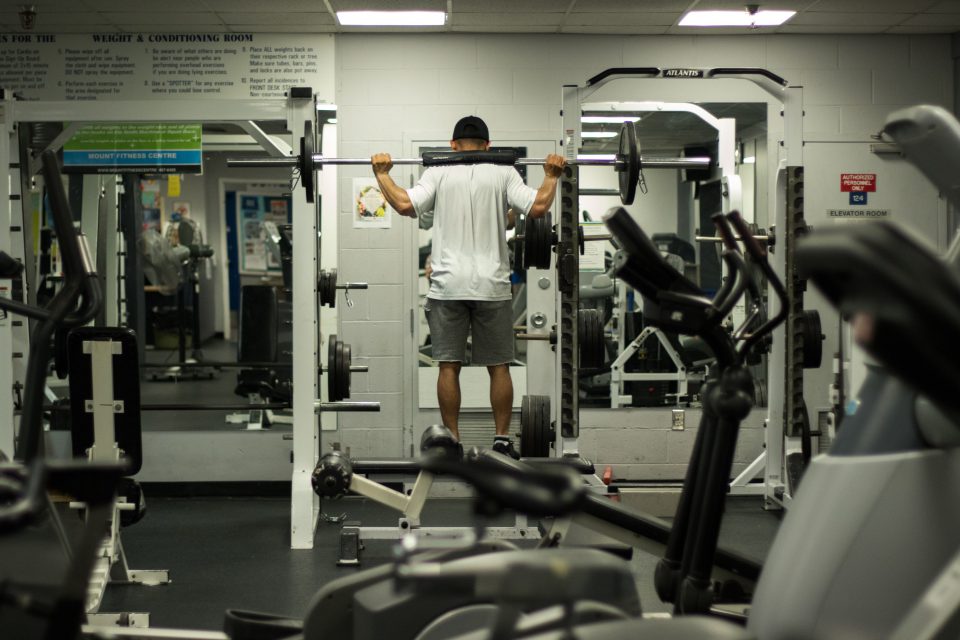 Man uses weight lifting equipment at the Mount Fitness Centre