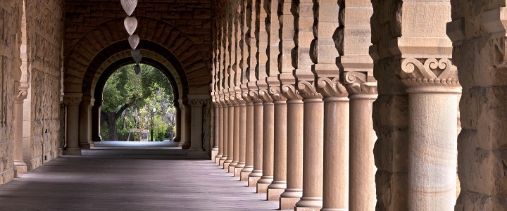 Archway with pallars leading out to an area with trees