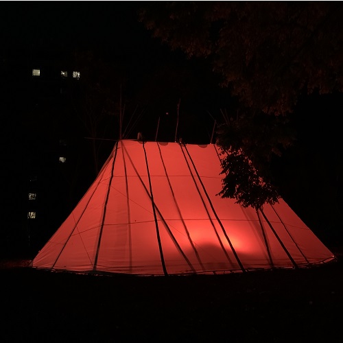 The Wikuom on the MSVU campus lit up with orange lights at night
