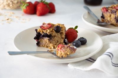 A piece of Baked Oatmeal with Berries and Apples on a plate