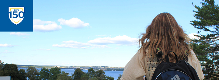 Student looking out over the Bedford Basin