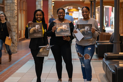 Three students holding up Hope for Wildlife calendars as part of Social Enterprise 4 a Day