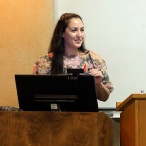 Jessica Mannette speaking at podium on World Aids Day