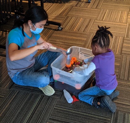 A Third-year Child and Youth Study student playing with a child from the Child Study Centre