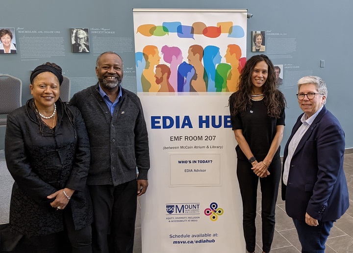 Delvina Bernard, EDIA Advisor; Robert Wright, social worker, sociologist, and leader in cultural competence training (guest speaker); Dr. El Jones, Assistant Professor, Political and Canadian Studies; Dr. Joël Dickinson, President and Vice-Chancellor in front of the Equity, Diversity, Inclusion and Accessibility (EDIA) Banner