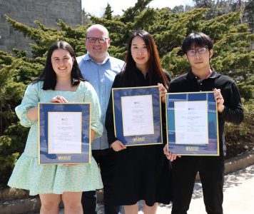 Julia Strickey, Sophia Jihye Hong, and Fei Xie receiving the Mount Co-op Students of the Year award