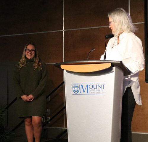 A student walking to the stage to receive an award