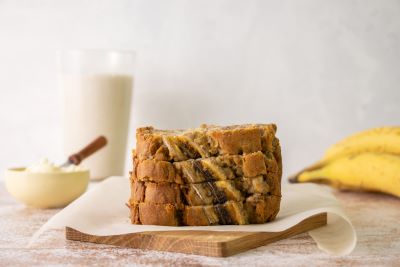 Four slices of Dairy and Gluten Free Coconut Banana Bread on a cutting board