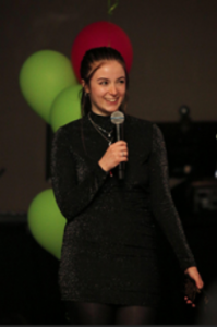 Cheyenne Hardy holding a microphone as an emcee