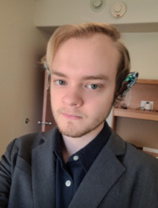 Valedictorian Michael Gillis standing in his university dorm room