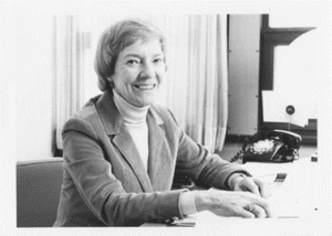 Sister Cecilia Margaret Young sitting beside a phone at her desk